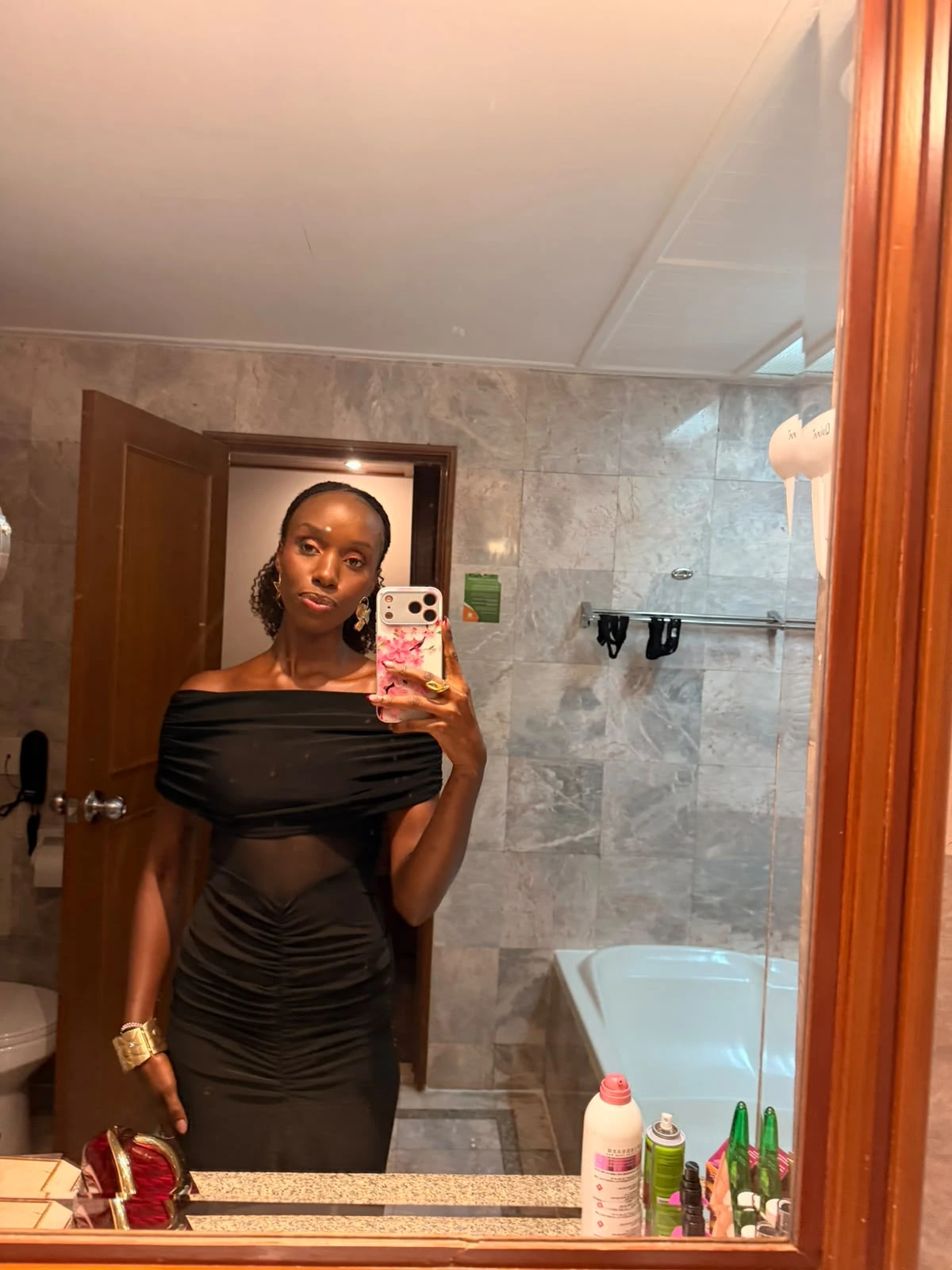 Mirror portrait of ZuriNiah in a black off-shoulder dress, facing the camera